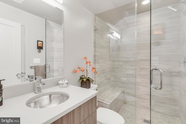 full bath featuring a shower stall, toilet, and vanity