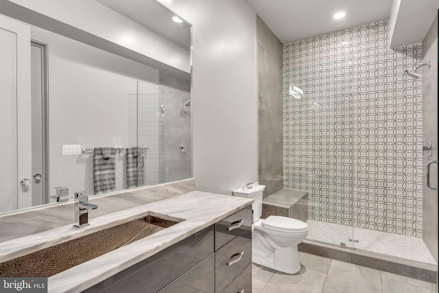 full bath with recessed lighting, toilet, a shower stall, vanity, and tile patterned flooring