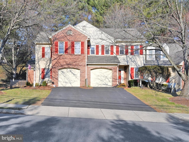 view of front of home with a garage, driveway, brick siding, and a front lawn