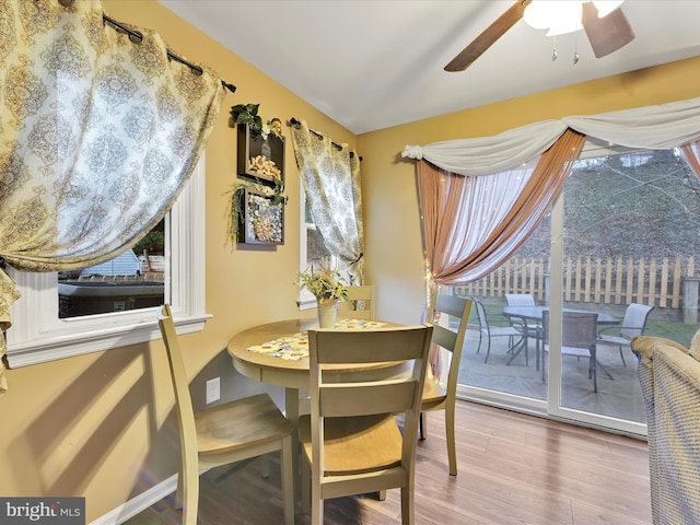 dining room with ceiling fan, baseboards, and wood finished floors