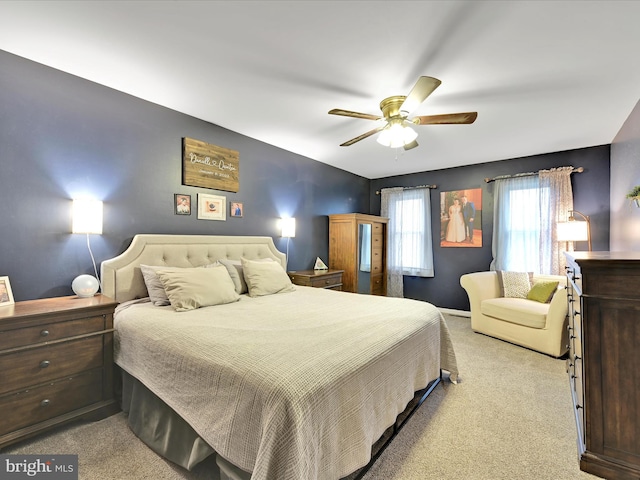 bedroom with light carpet and ceiling fan