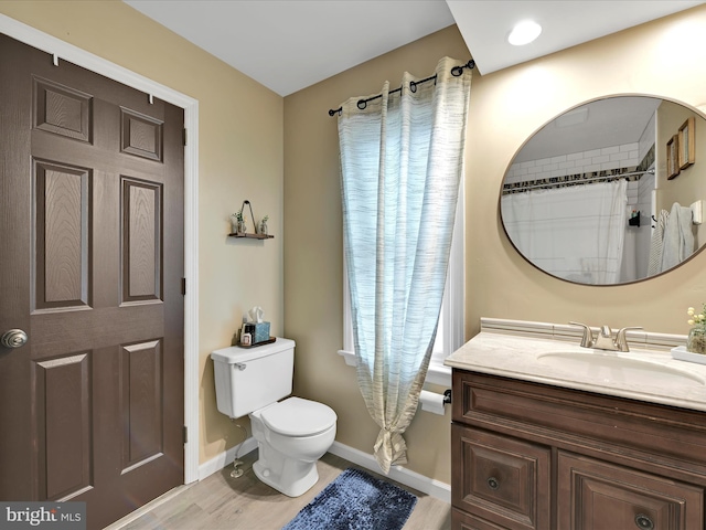 full bathroom featuring toilet, baseboards, and vanity