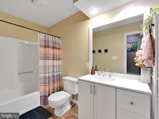 full bath with toilet, wood finished floors, visible vents, vanity, and shower / bathtub combination with curtain