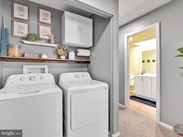 laundry room featuring laundry area, baseboards, washer and clothes dryer, carpet, and a sink