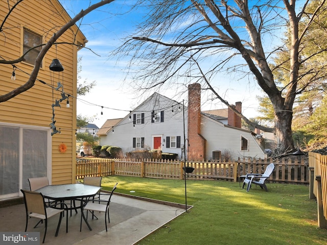 view of yard with fence and a patio