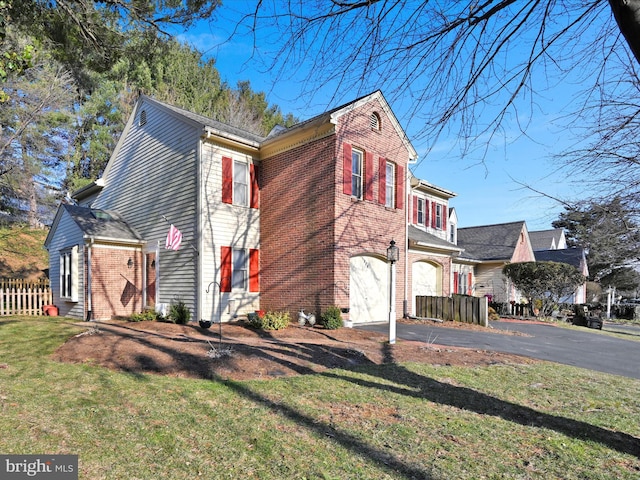 view of side of home with aphalt driveway, an attached garage, fence, and brick siding