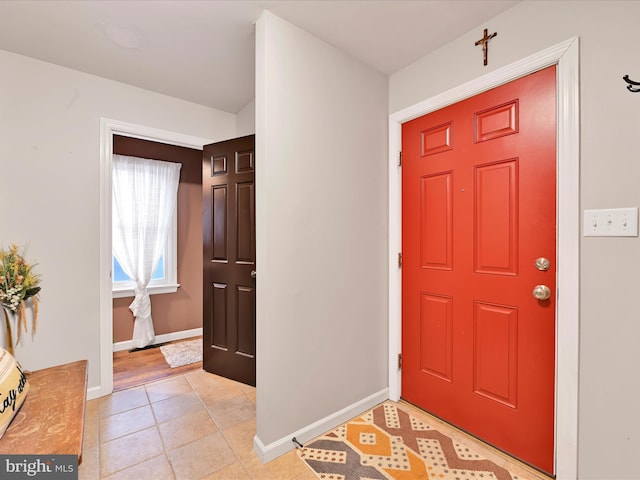 entrance foyer featuring baseboards and light tile patterned flooring