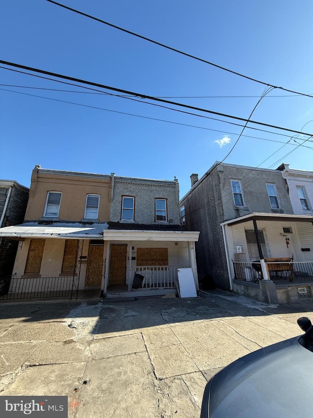 townhome / multi-family property featuring a porch