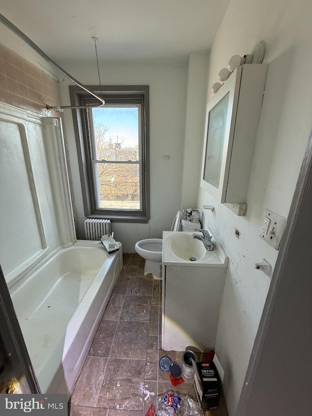 full bathroom featuring stone finish flooring, toilet, radiator heating unit, shower / bathing tub combination, and vanity