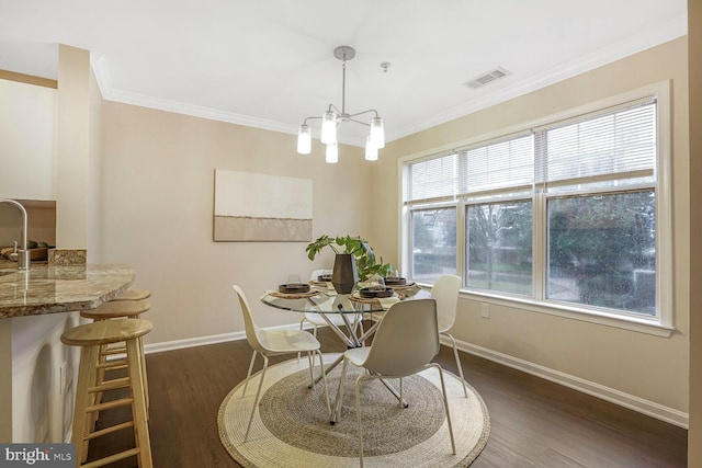 dining space with dark wood finished floors, visible vents, baseboards, and ornamental molding