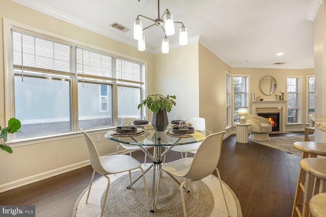 dining area featuring visible vents, ornamental molding, and dark wood-style flooring