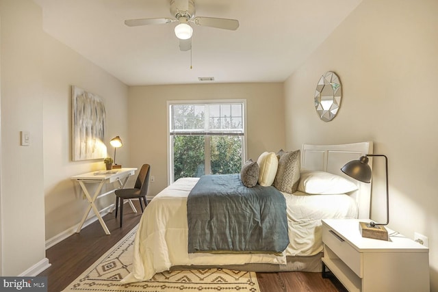 bedroom with a ceiling fan, visible vents, dark wood-style flooring, and baseboards