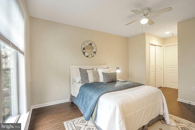 bedroom featuring a closet, a ceiling fan, baseboards, and wood finished floors