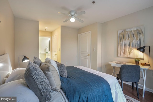 bedroom featuring a ceiling fan, wood finished floors, baseboards, and connected bathroom