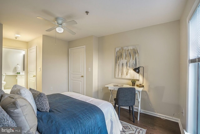 bedroom with a ceiling fan, baseboards, dark wood-type flooring, and ensuite bathroom