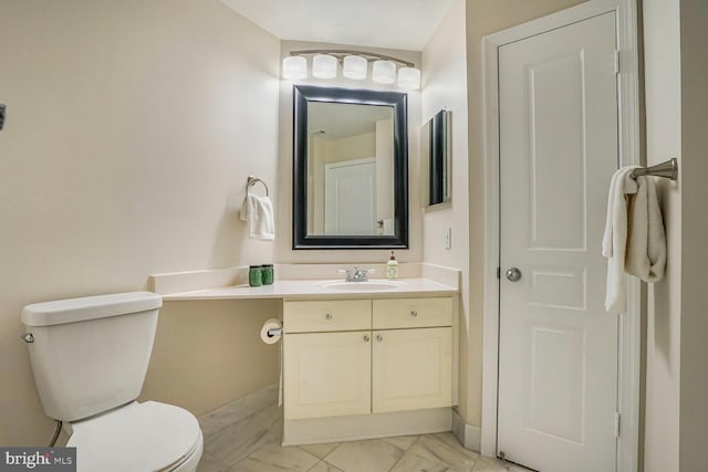 bathroom featuring marble finish floor, toilet, and vanity