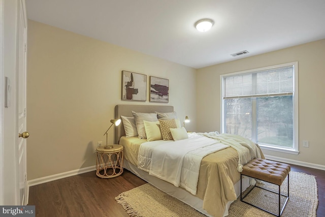 bedroom featuring visible vents, baseboards, and dark wood-style flooring