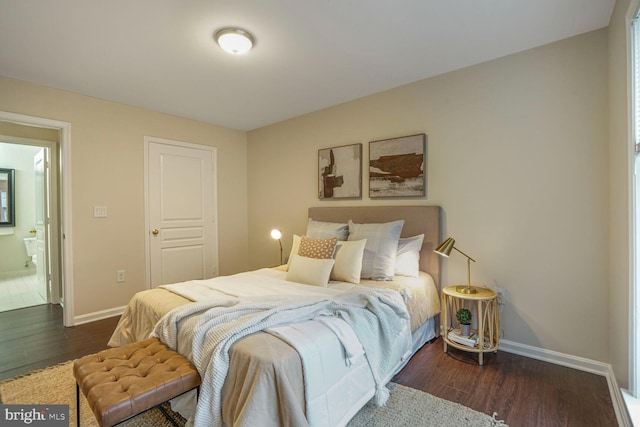 bedroom with baseboards and wood finished floors