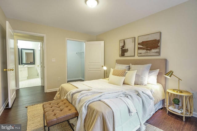 bedroom with a closet, baseboards, and wood finished floors