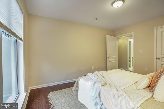 bedroom featuring baseboards and wood finished floors