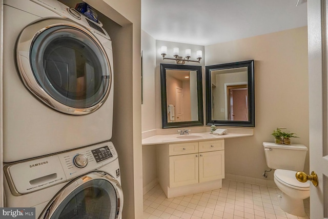 clothes washing area featuring light tile patterned floors, baseboards, laundry area, a sink, and stacked washer / dryer