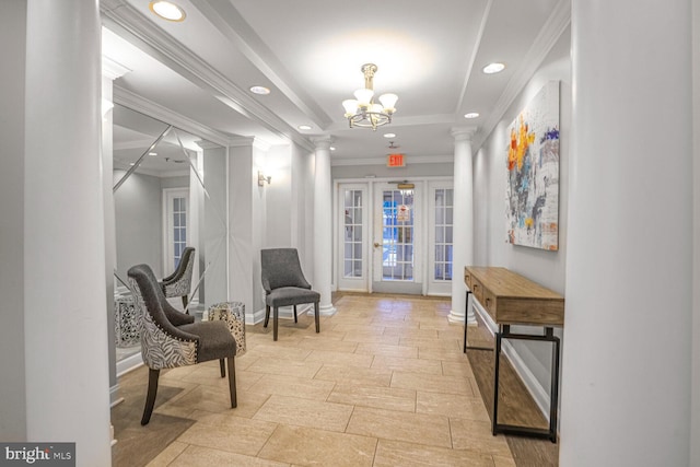 interior space with french doors, crown molding, baseboards, and decorative columns