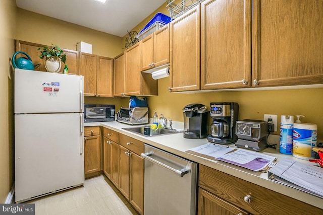 kitchen with freestanding refrigerator, a sink, light countertops, black microwave, and dishwasher