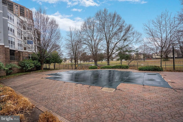 view of swimming pool with fence