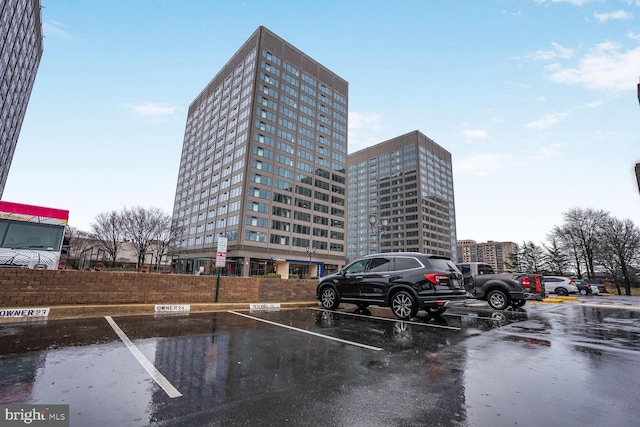 view of building exterior featuring uncovered parking