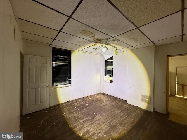 unfurnished room featuring a drop ceiling, visible vents, and a ceiling fan