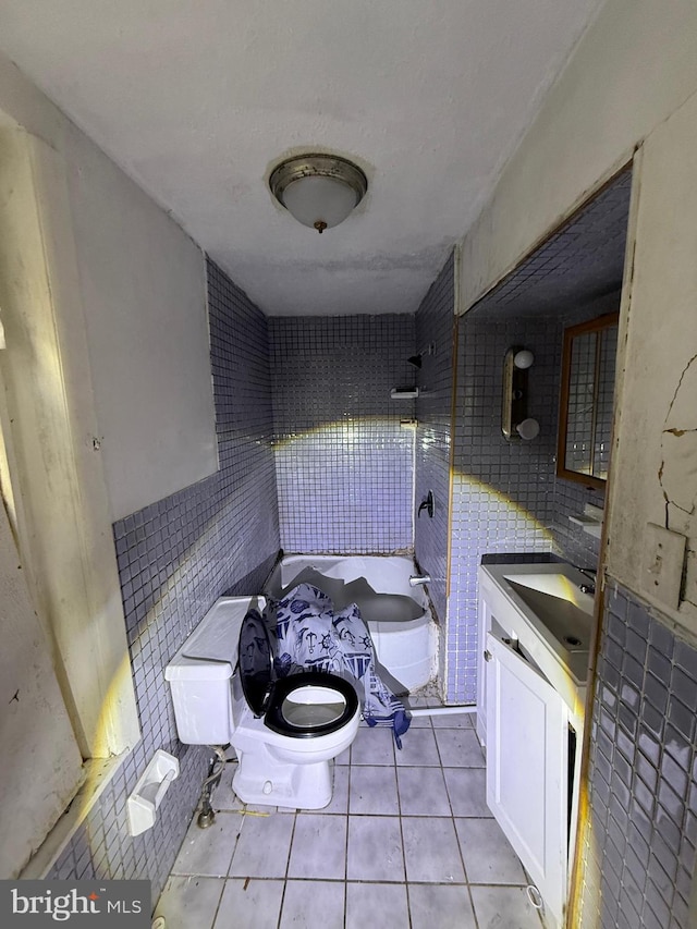 full bathroom with vanity, shower / bathing tub combination, tile walls, toilet, and tile patterned floors