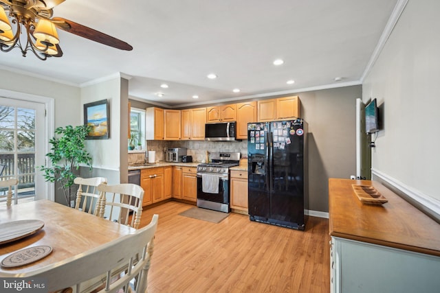 kitchen with tasteful backsplash, baseboards, light wood-style flooring, ornamental molding, and stainless steel appliances