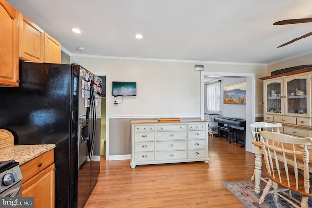 kitchen with light wood-type flooring, a ceiling fan, crown molding, and black fridge with ice dispenser