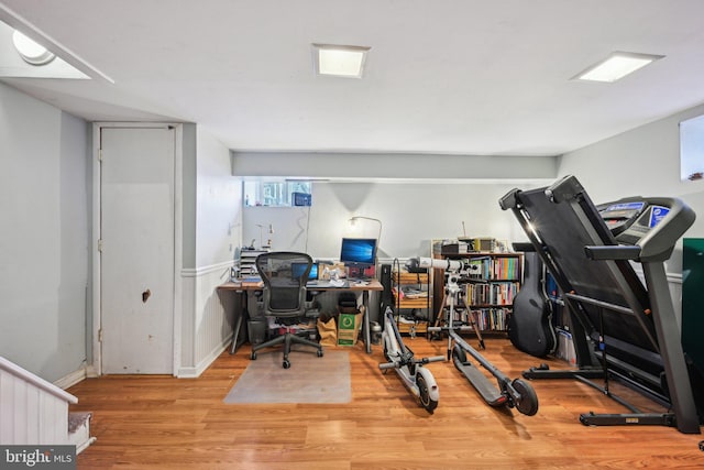 office area featuring baseboards and wood finished floors