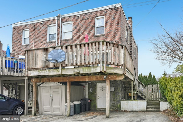 view of front of house with brick siding and stairway