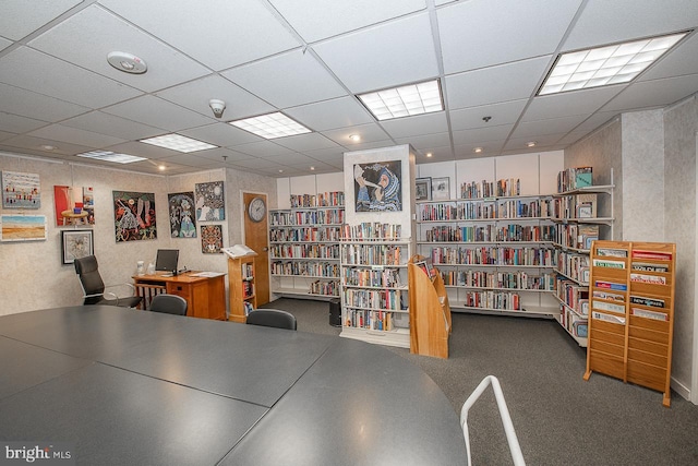 office area featuring a paneled ceiling and bookshelves