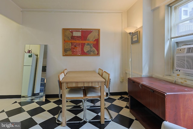 dining space with cooling unit, baseboards, and tile patterned floors