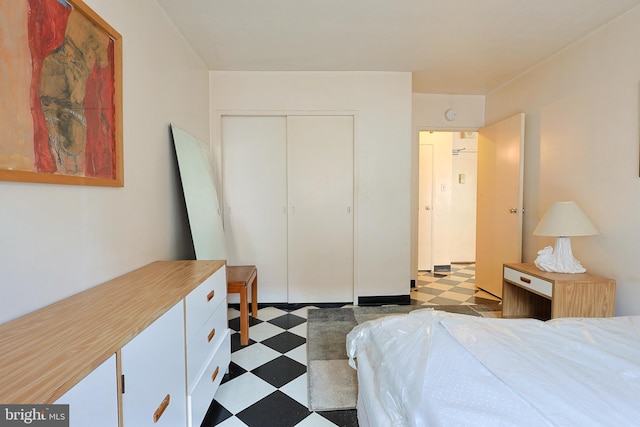 bedroom with a closet and tile patterned floors