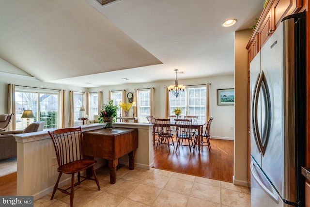 dining room with light tile patterned floors, recessed lighting, a notable chandelier, and a healthy amount of sunlight