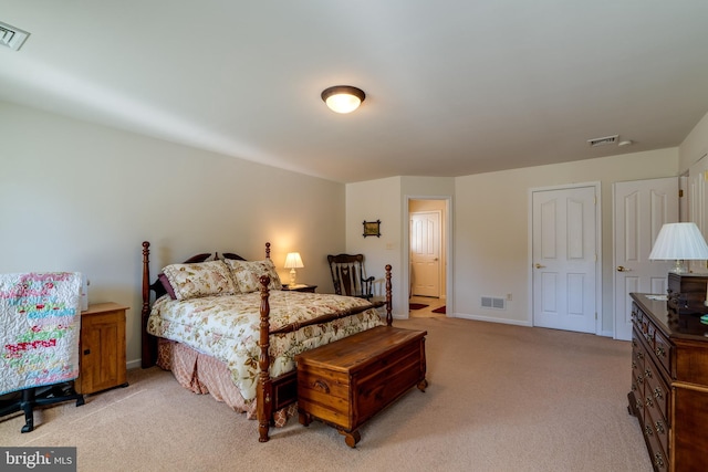 bedroom with visible vents, light carpet, and baseboards