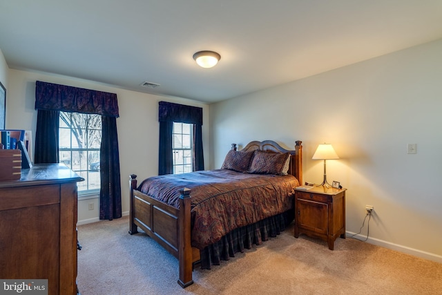 bedroom featuring light carpet, visible vents, and baseboards