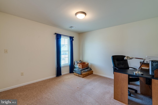 carpeted office space featuring visible vents and baseboards