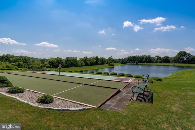 view of property's community with a water view and a yard