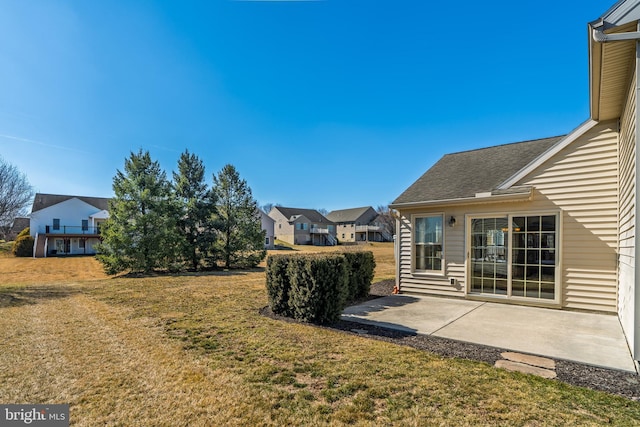 view of yard featuring a patio area and a residential view