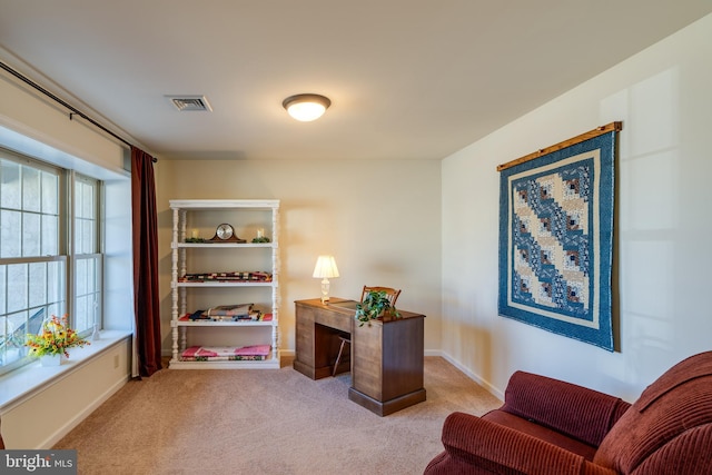 carpeted office with visible vents and baseboards