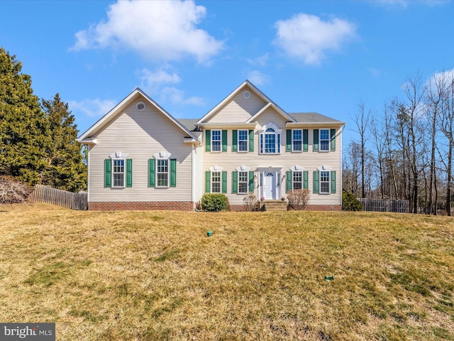 colonial inspired home featuring fence and a front lawn