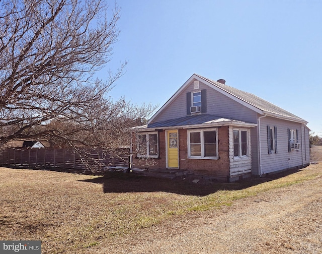 view of front facade with a front lawn, cooling unit, and fence