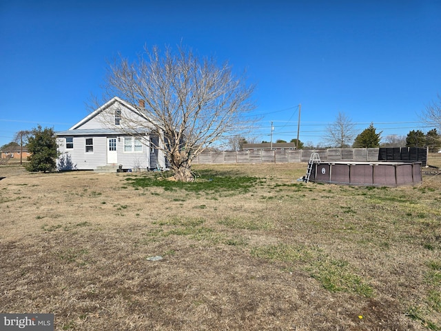 view of yard with entry steps and fence