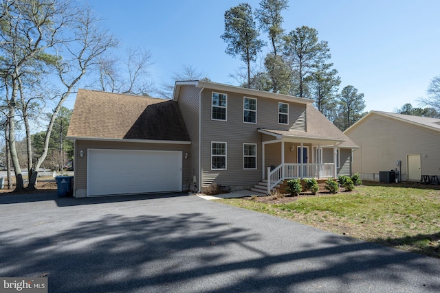 view of front of house with driveway, cooling unit, covered porch, an attached garage, and a shingled roof