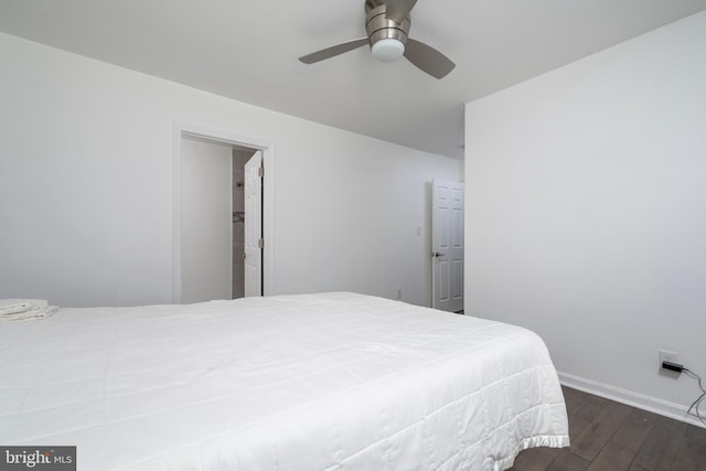 bedroom featuring a ceiling fan, baseboards, and wood-type flooring